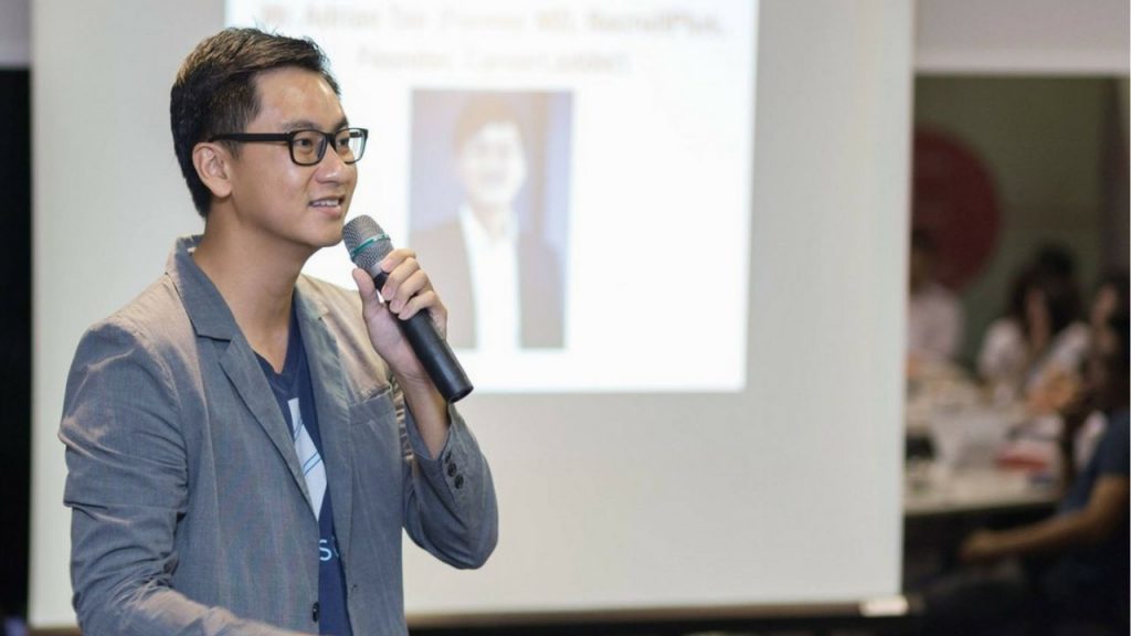 Adrian Tan speaking at a conference